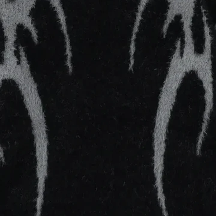 Close-up of the jumper: the grey flame yarn running through the black knit
